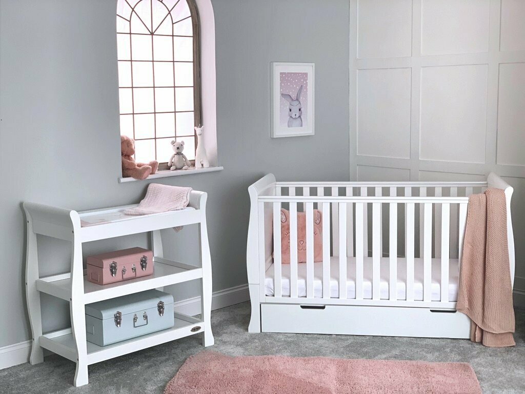 white cot and changing unit